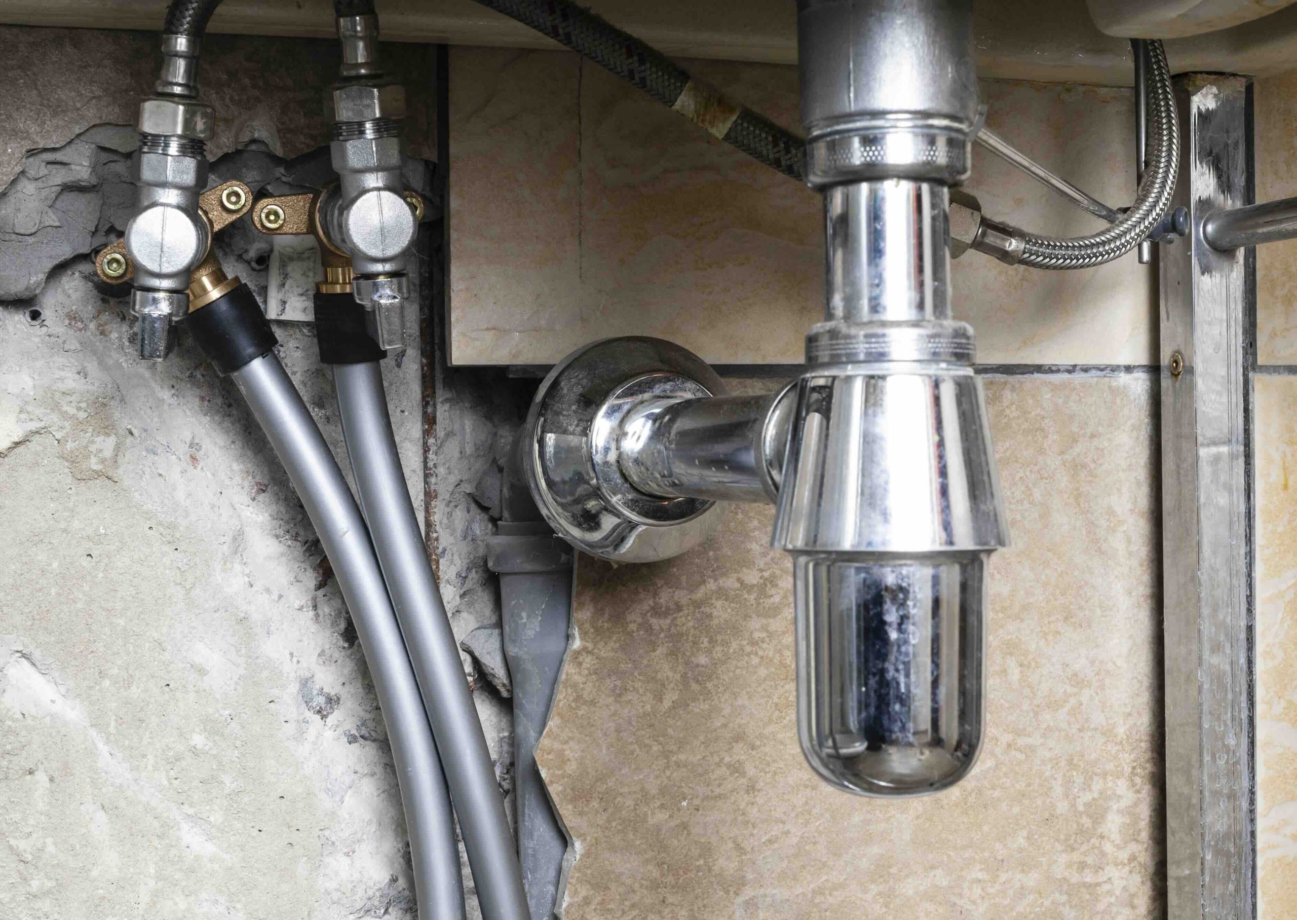 A silver pipe and waterline in need of repair.