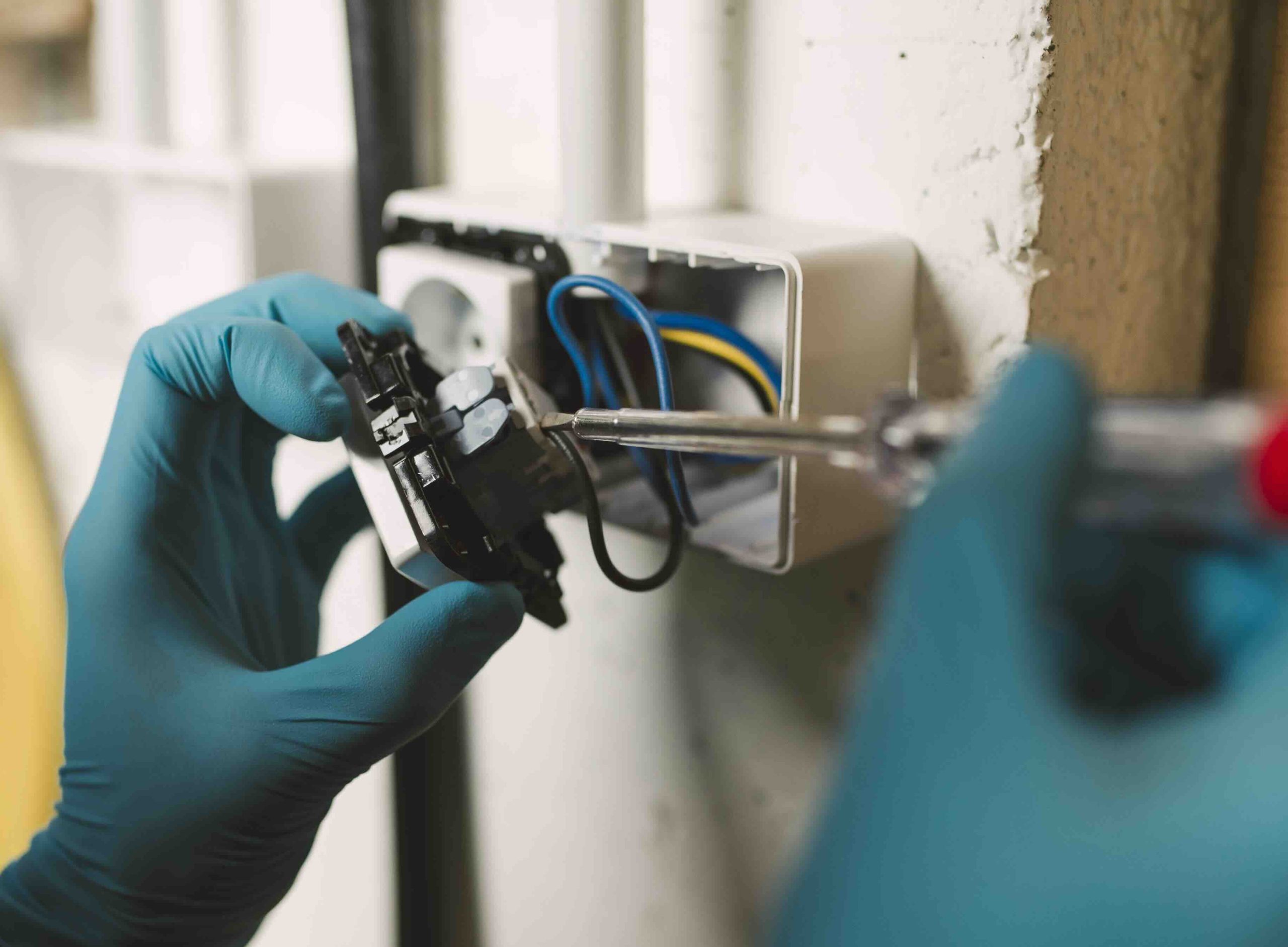 preventive electrical maintenance A photo of an electrician performing preventive electrical maintenance.