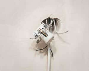Photo of an exposed wire, just one of many dangers behind electrical emergencies.
