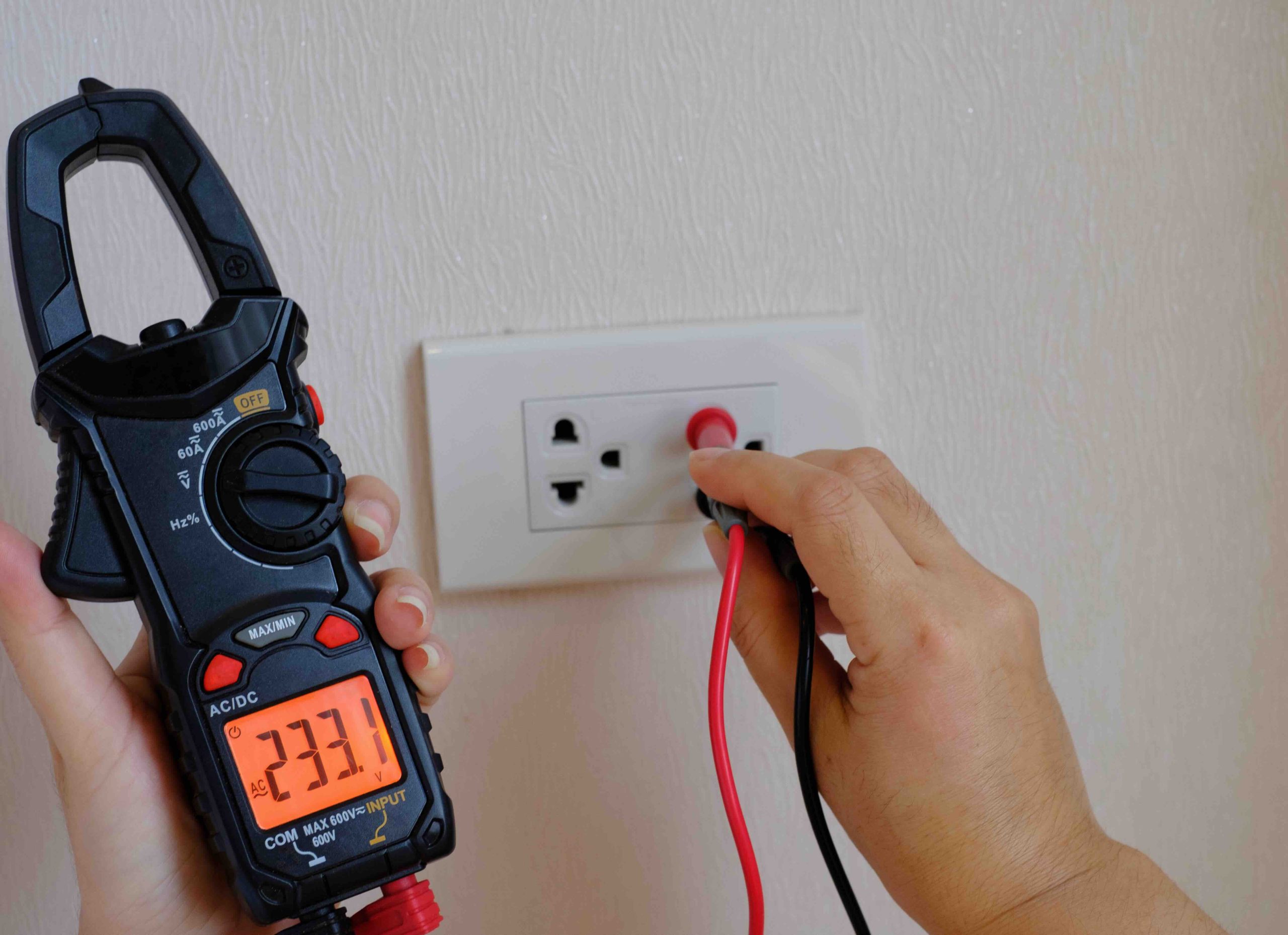 Photo of an electrician performing an electrical safety inspection.