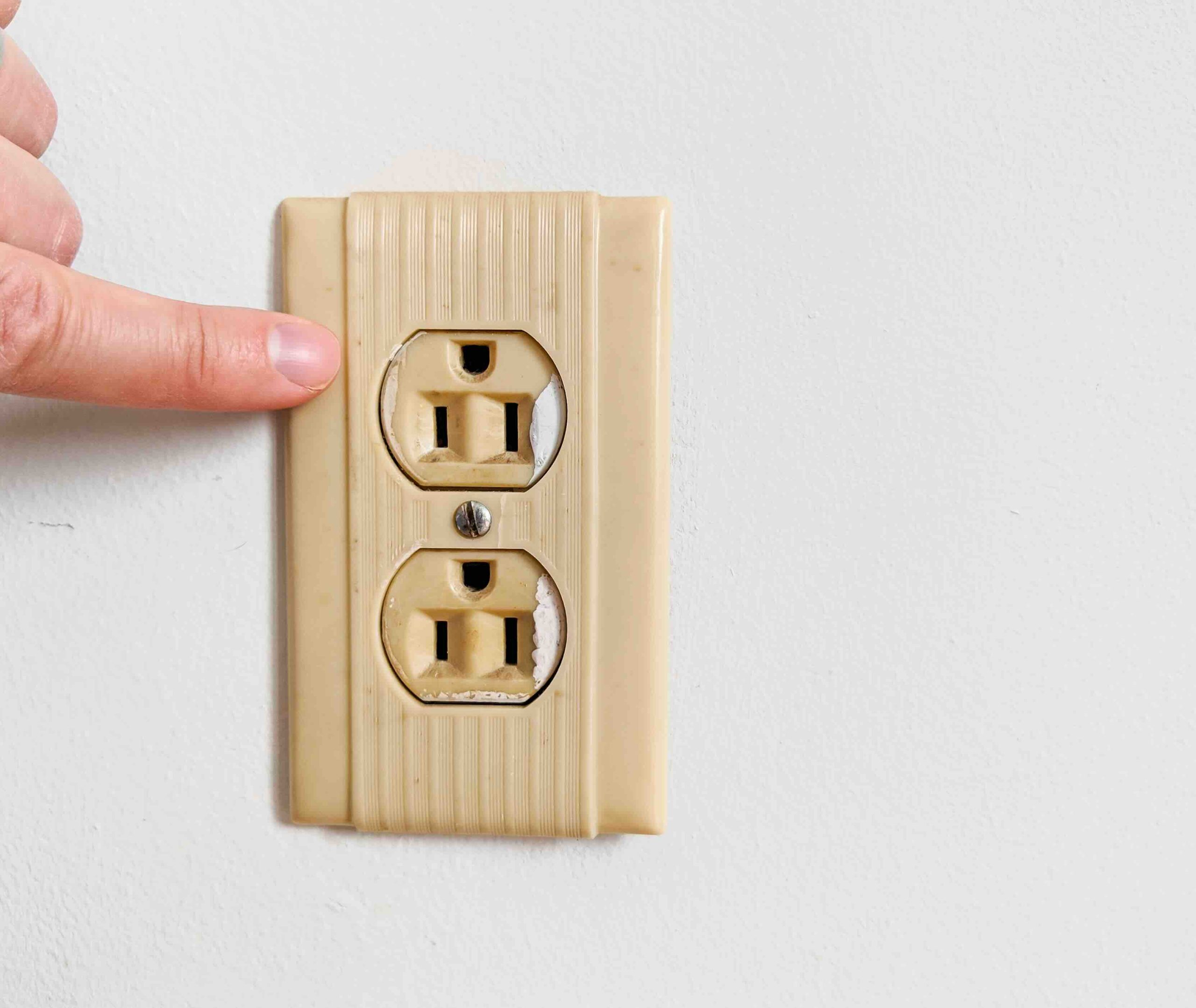 A photo of old electrical outlets that need replacing.