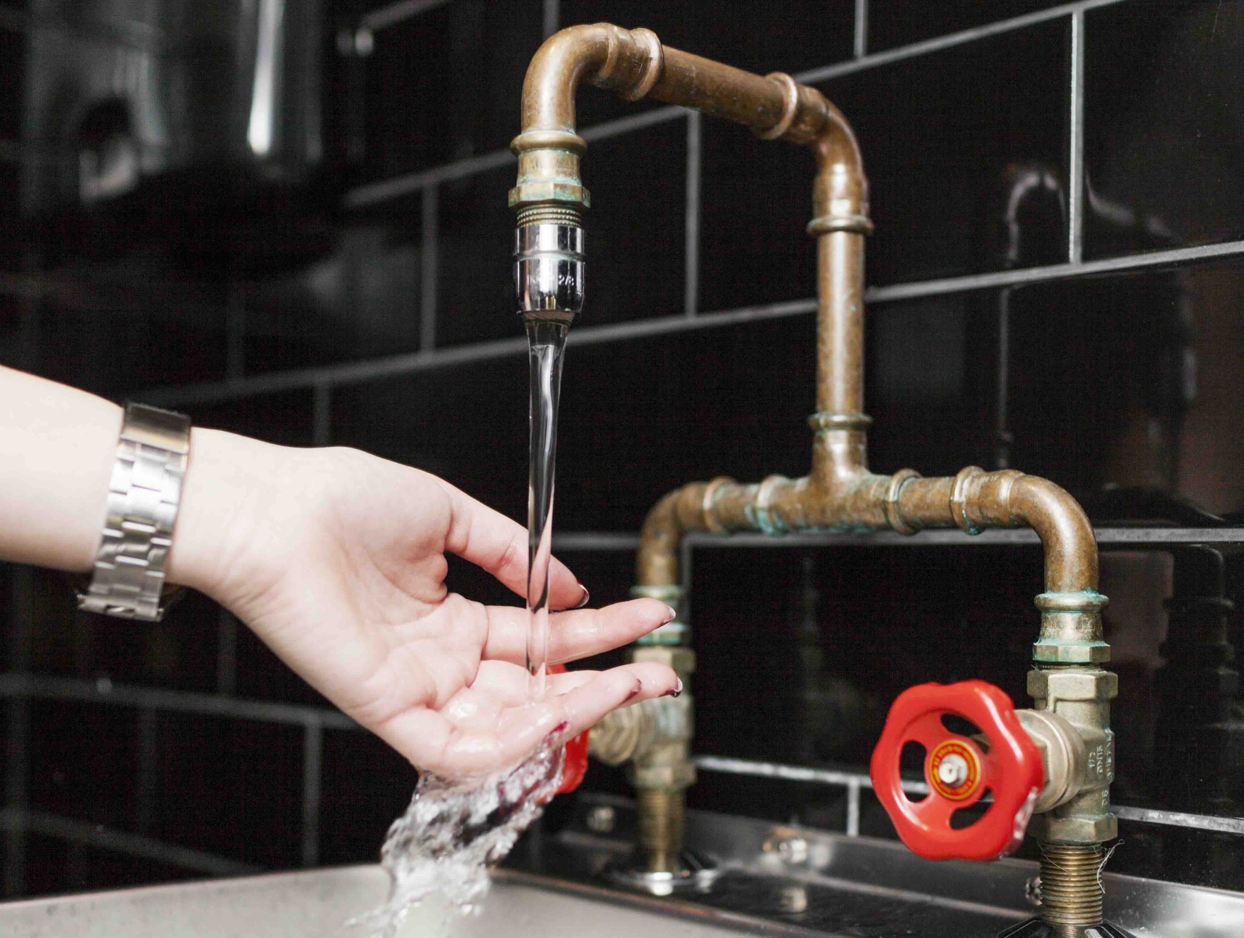 A photo of a copper pipe faucet in need of repair.